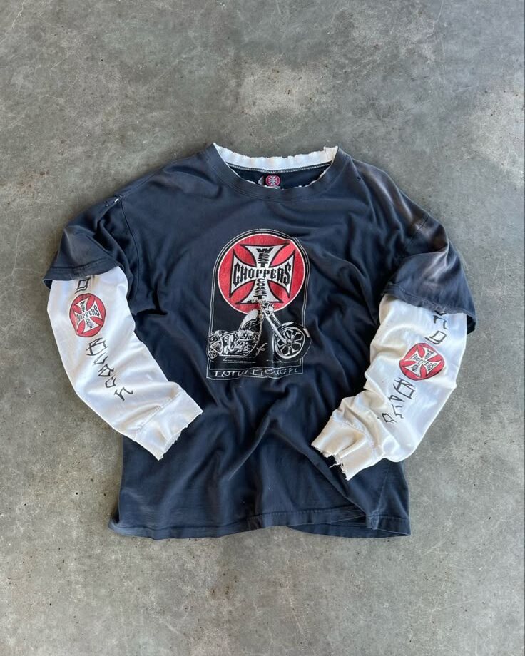 Vintage West Coast Choppers long sleeve shirt laid flat on plain concrete, shot from directly above in natural light