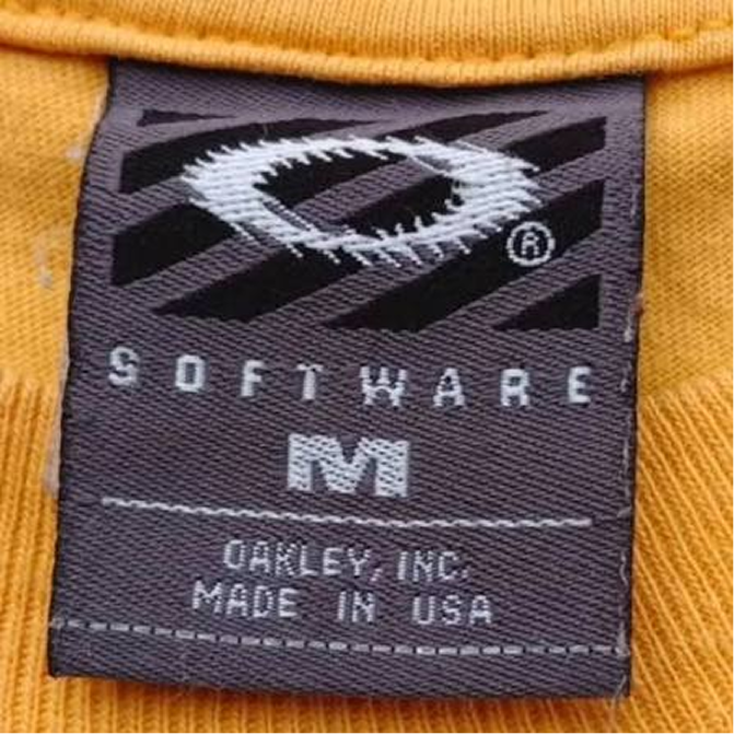 Charcoal woven Oakley Software tag with the elliptical O logo, size M, marked Oakley Inc. Made in USA